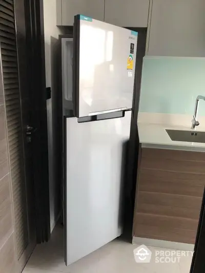 Modern kitchen with sleek fridge and stylish cabinetry