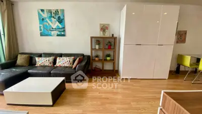 Modern living room with sleek furniture and vibrant decor in a stylish apartment.