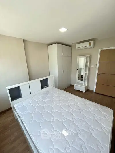Spacious bedroom with modern furniture and ample natural light in a stylish apartment.