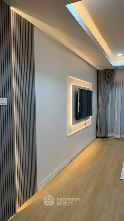 Modern living room with sleek TV setup and ambient lighting