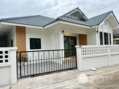 Charming single-story house with modern design and gated entrance, perfect for family living.