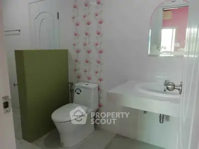 Modern bathroom with floral accent wall and sleek fixtures