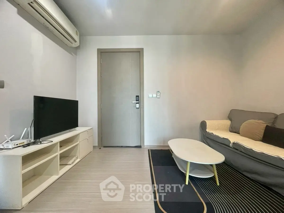 Modern living room with sleek furniture and air conditioning, perfect for comfortable urban living.