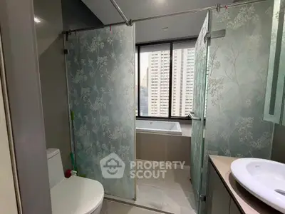 Modern bathroom with glass shower and city view window
