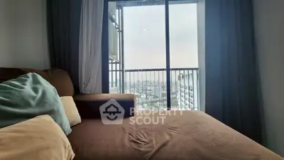 Cozy living room with a stunning city view from the balcony, perfect for relaxation and enjoying the skyline.