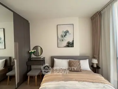 Modern bedroom with stylish decor and natural light, featuring a cozy bed and elegant furnishings.