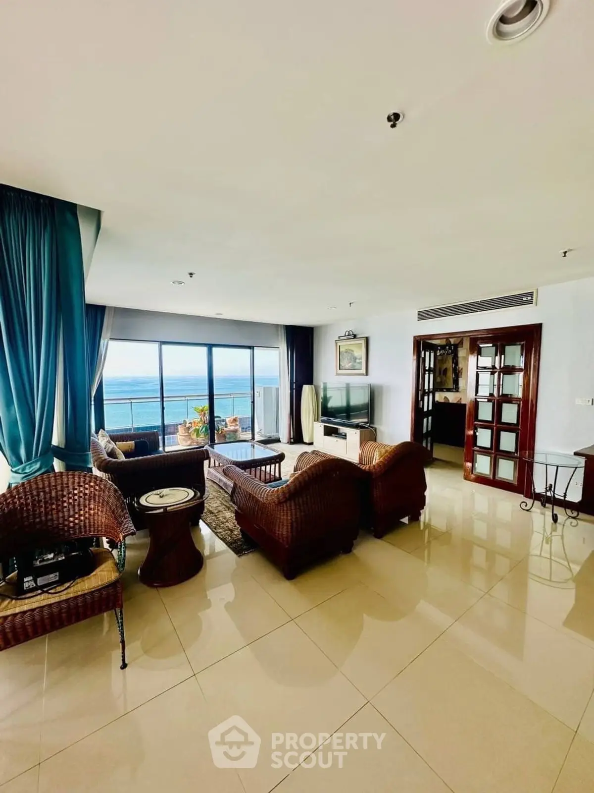 Spacious living room with ocean view and elegant wicker furniture