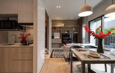 Modern open-plan living room and kitchen with stylish decor and natural light.
