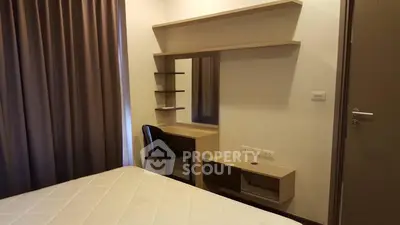 Cozy bedroom with modern vanity and comfortable bed, perfect for relaxation.