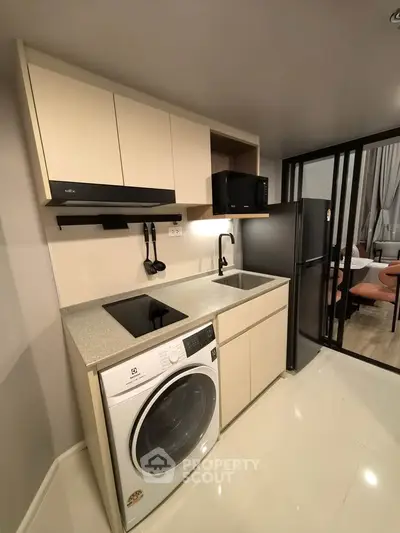 Modern kitchen with sleek appliances and open layout in stylish apartment