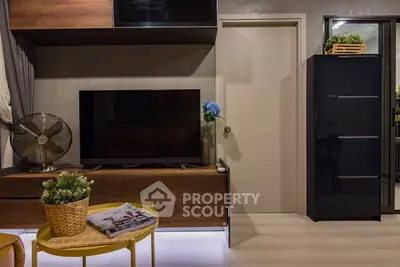 Stylish modern living room with TV, wooden furniture, and decorative plants.