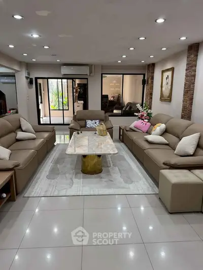 Spacious living room with modern furniture and elegant decor, perfect for family gatherings.