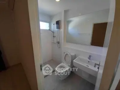 Modern bathroom with sleek fixtures and spacious shower area