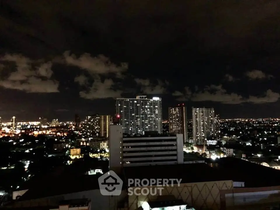 Stunning night cityscape view with illuminated skyline and high-rise buildings.