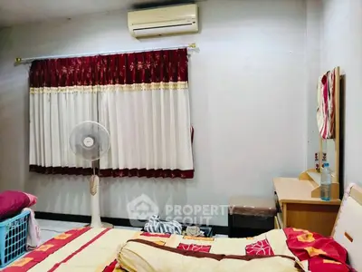 Cozy bedroom with air conditioning and stylish curtains