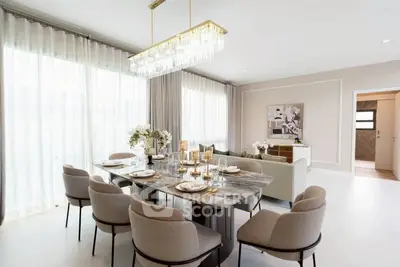 Luxurious dining room with elegant chandelier and marble table, perfect for entertaining.