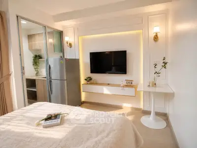 Modern studio apartment with cozy bedroom and sleek kitchen area, featuring elegant lighting and stylish decor.