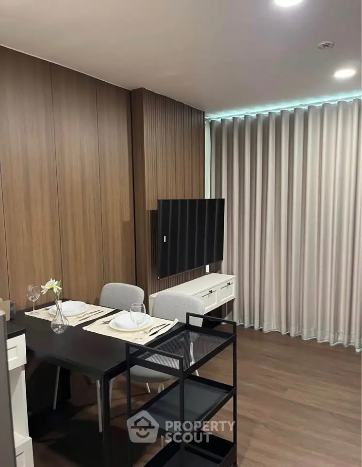 Modern dining area with sleek wooden paneling and elegant table setting in a contemporary apartment.