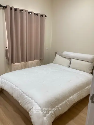 Cozy bedroom with soft lighting and elegant curtains, perfect for relaxation.