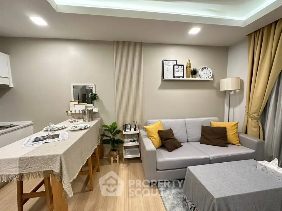 Modern living room with cozy sofa, stylish decor, and dining area in open layout.