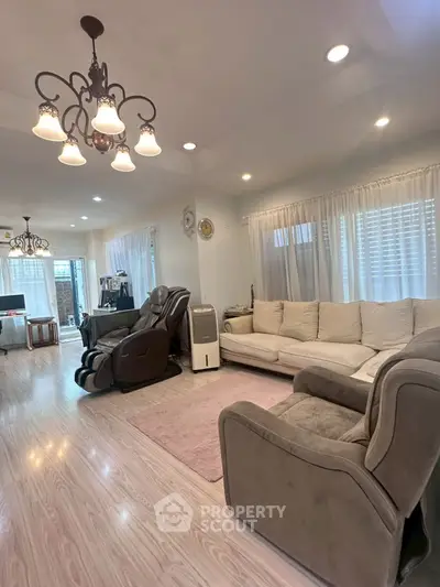Spacious living room with elegant lighting and cozy seating area.