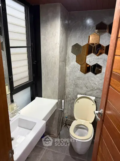 Modern bathroom with stylish hexagonal mirrors and sleek fixtures