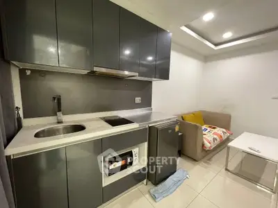 Modern compact kitchen with sleek cabinets and cozy living area