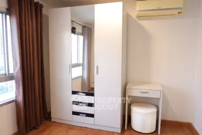 Spacious bedroom with modern wardrobe and natural light
