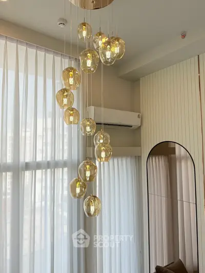 Elegant modern living room with stylish pendant lights and large windows