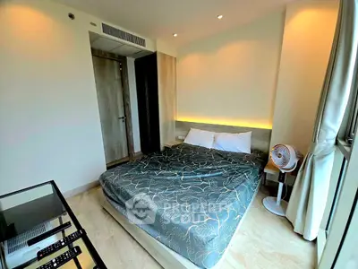 Cozy bedroom with modern decor and large window for natural light