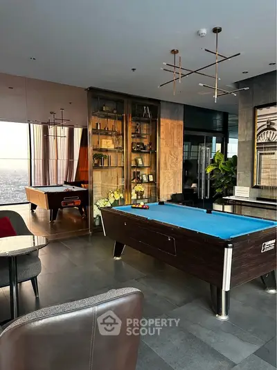 Luxurious penthouse with billiard table and stunning city view, perfect for entertainment and relaxation.