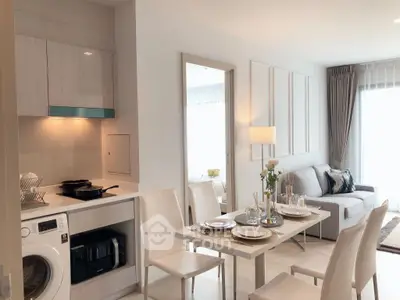Modern open-plan living room and kitchen with elegant dining area and natural light.