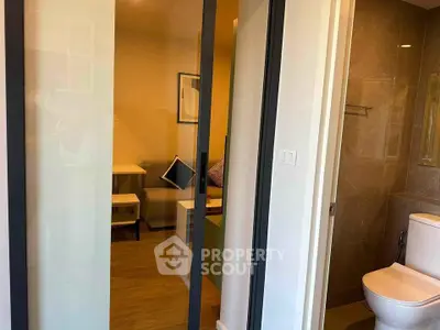 Modern apartment interior with sliding glass doors and cozy living area.