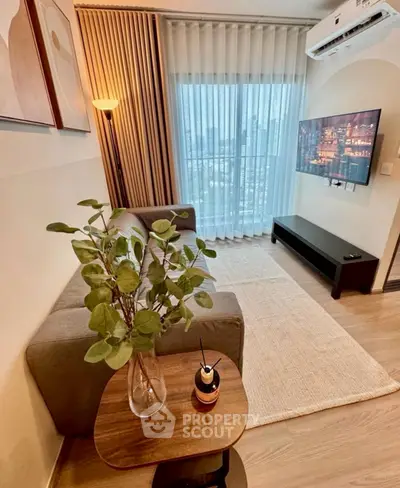 Modern living room with city view, cozy sofa, and wall-mounted TV in stylish apartment.