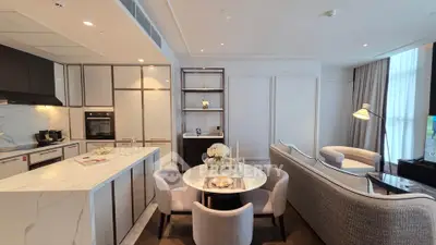 Luxurious open-plan living room and kitchen with elegant furnishings and modern appliances.