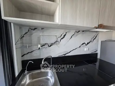 Modern kitchen with sleek marble backsplash and stainless steel sink