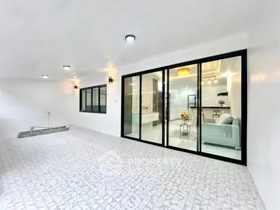 Spacious modern living room with glass doors and elegant lighting