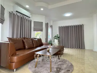 Spacious living room with modern brown leather sofa and elegant decor