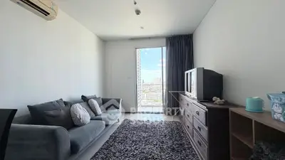 Modern living room with cozy sofa and city view from window