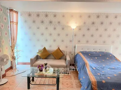 Charming bedroom with cozy sofa and elegant decor, perfect for relaxation and comfort.
