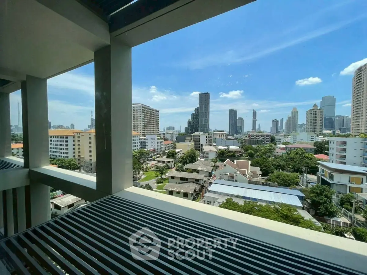Stunning cityscape view from a modern balcony in a high-rise building.