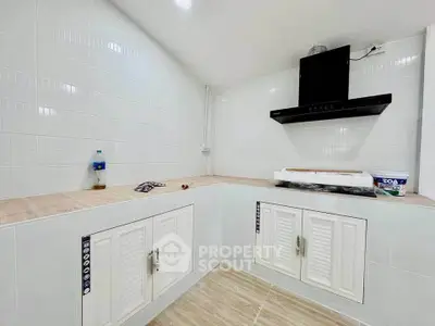 Modern kitchen with sleek white cabinets and stylish range hood