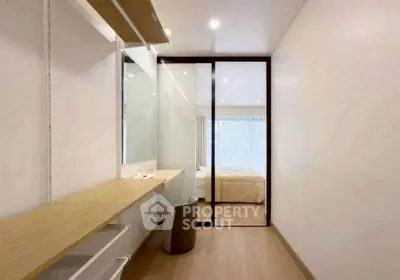 Modern minimalist bedroom with sliding glass door and wooden accents