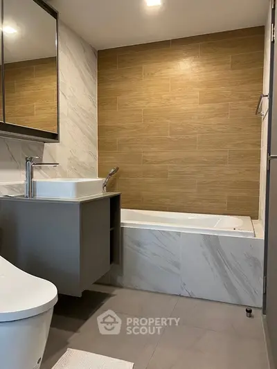 Modern bathroom with elegant marble tiles and built-in bathtub