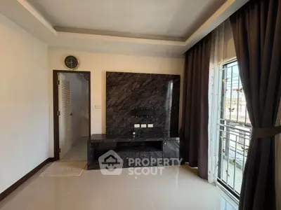 Modern living room with marble TV wall and large window view