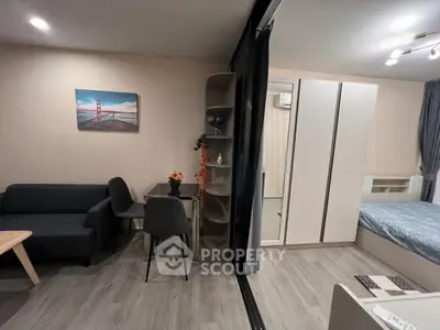 Modern studio apartment with stylish decor and open layout, featuring a cozy living area and comfortable bedroom.