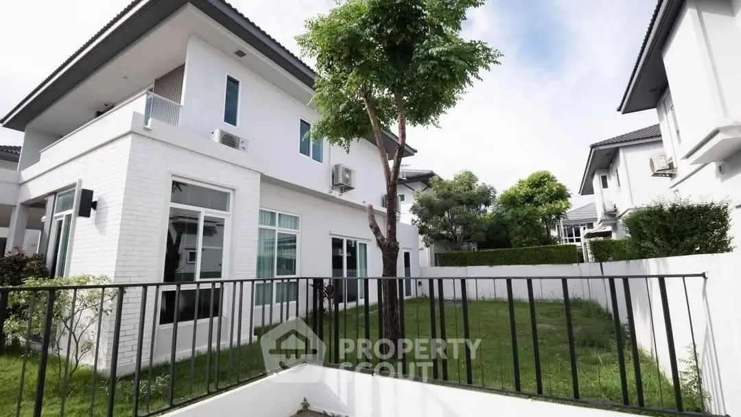 Modern two-story house with lush garden and spacious balcony