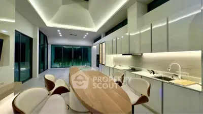 Luxurious modern kitchen with sleek design and open layout, featuring elegant dining area and ambient lighting.