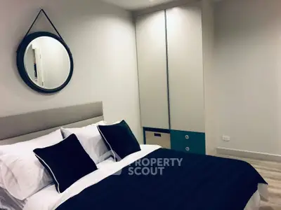 Modern bedroom with stylish decor and cozy bedding in a contemporary apartment.