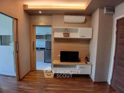 Modern living room with wooden flooring and built-in TV unit